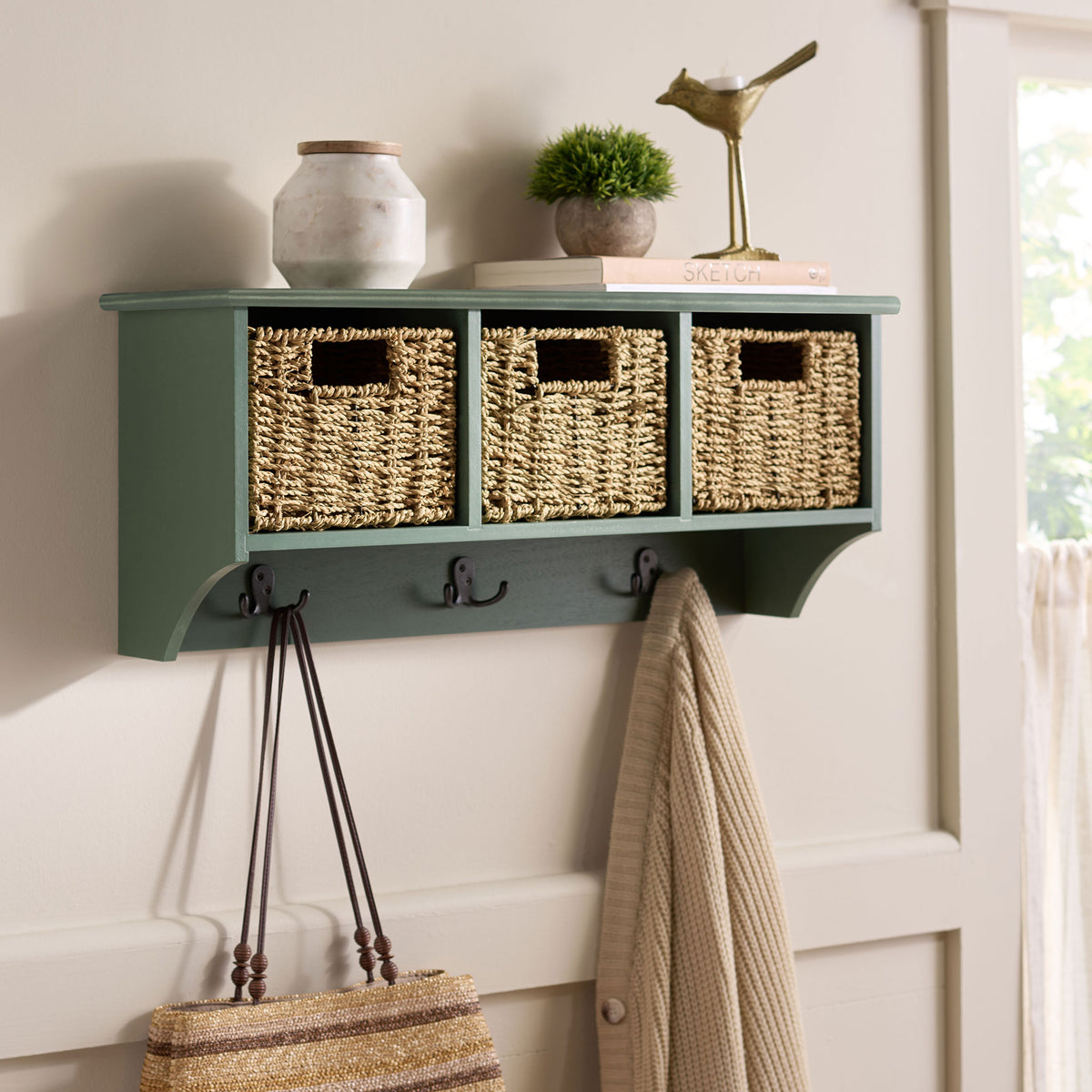A dusty green rack brings woven storage and handy coat hooks to the entryway wall || HAC5700G || front_angle_room