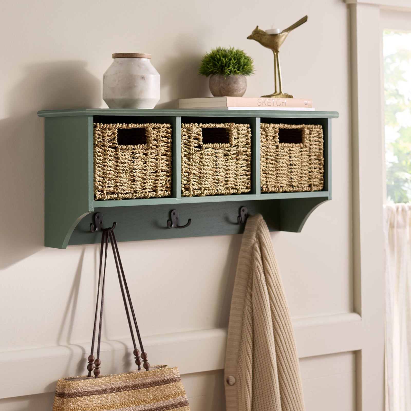 A dusty green rack brings woven storage and handy coat hooks to the entryway wall || HAC5700G || front_angle_room