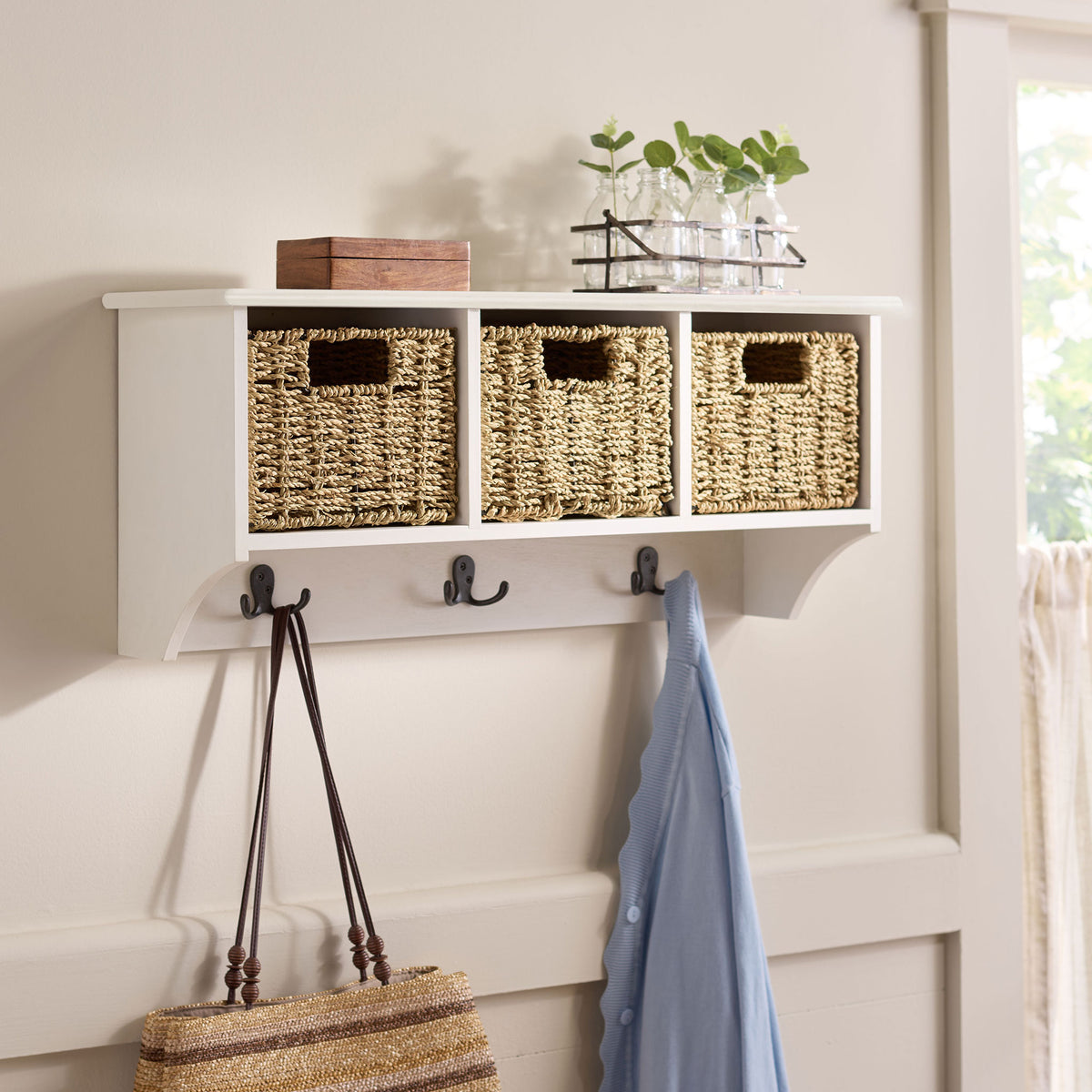 Ivory wall storage organizes baskets and outerwear while leaving room for decor on top || HAC5700H || front_angle_room