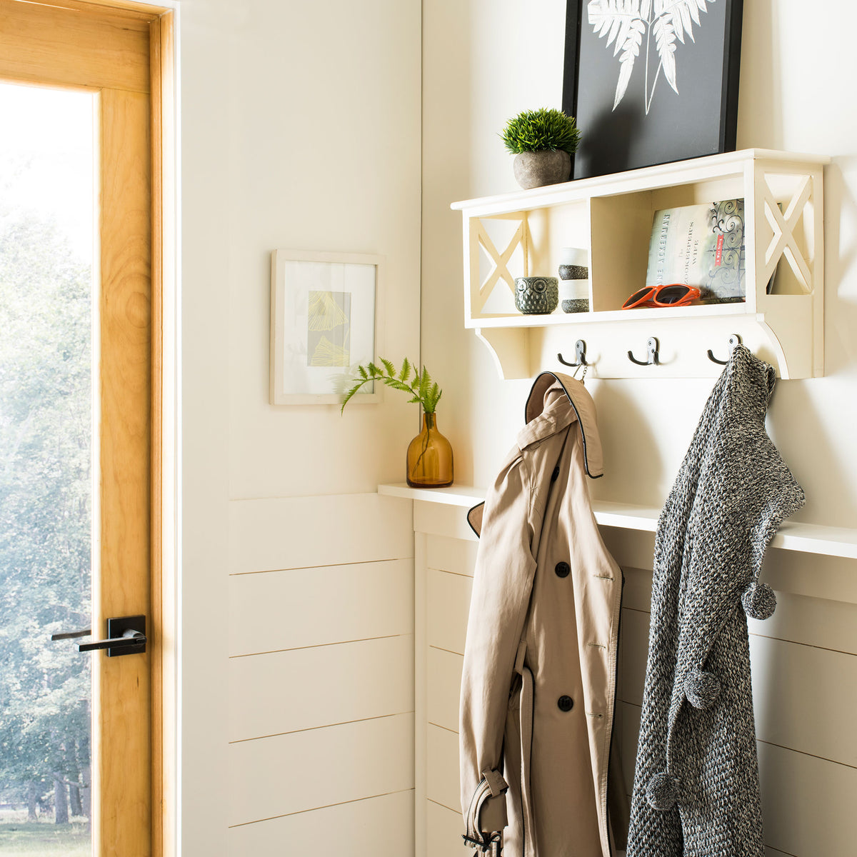 White wall rack provides open cubbies for essentials and dark hooks for coats. || HAC5703C || front_angle_room