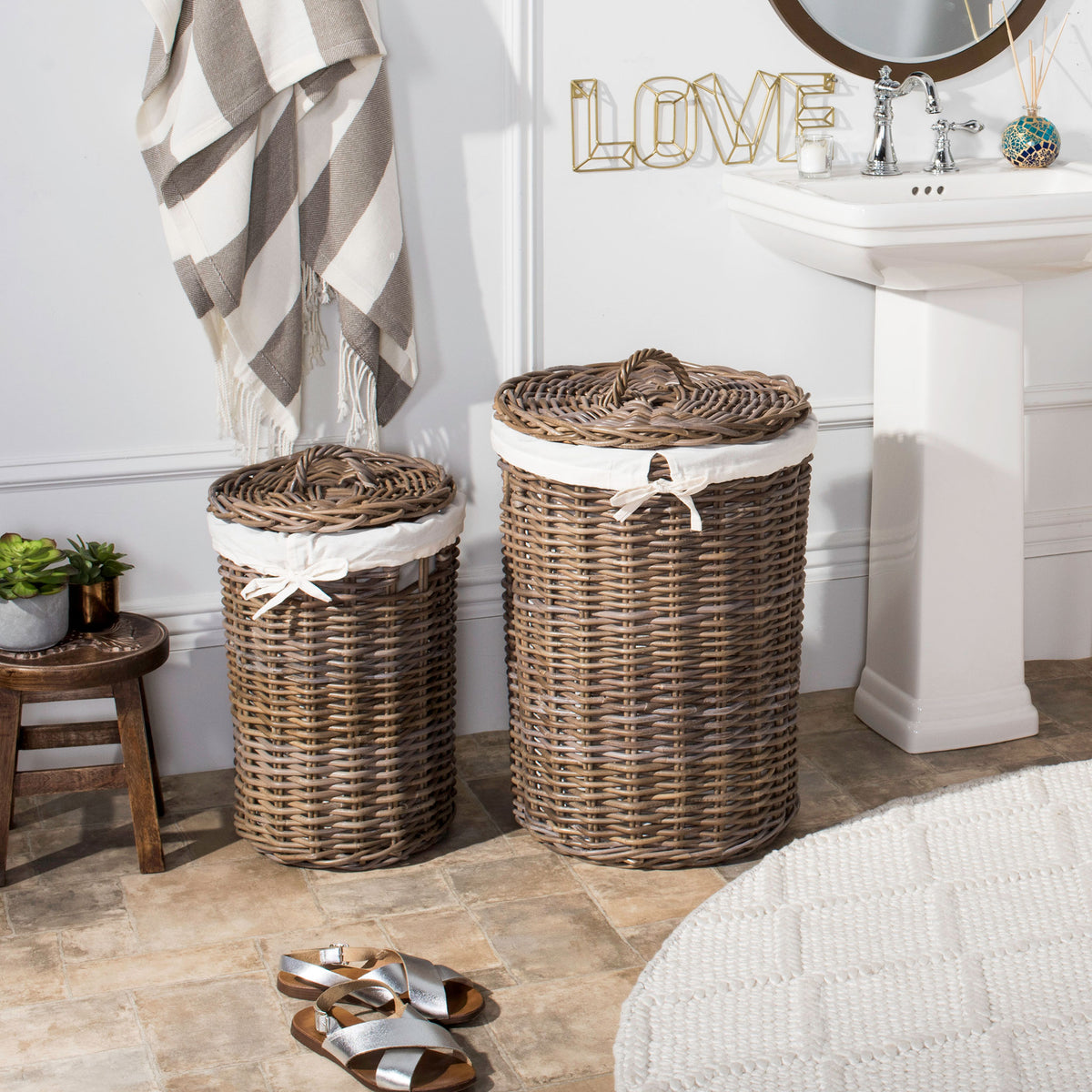 Two lidded rattan hampers bring warm natural texture and white bow-tied liners to the bathroom. || HAC6001A || front_room