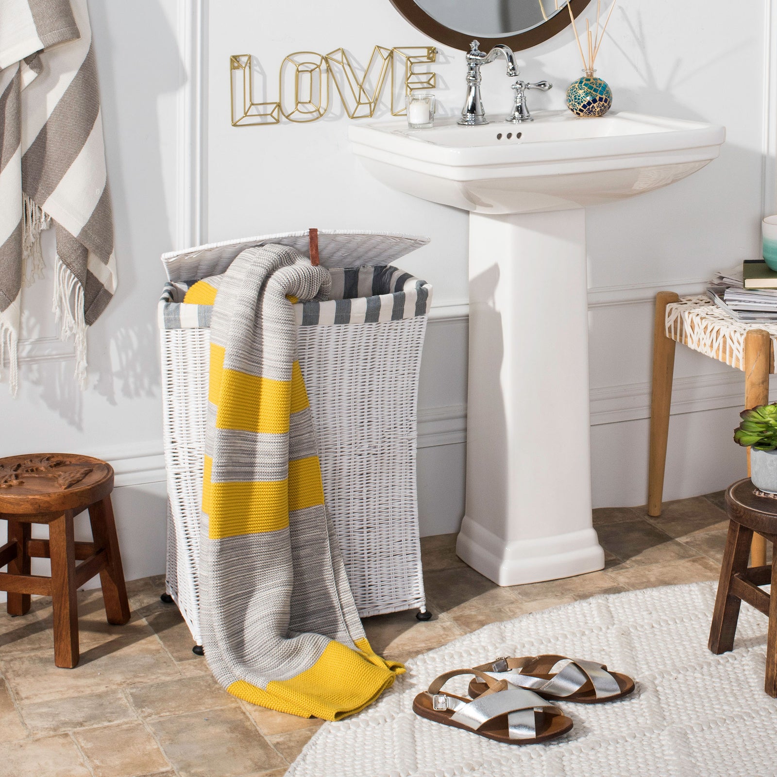 An open white woven hamper offers easy access, with a towel draped over its striped rim. || HAC6002A || front_open_room