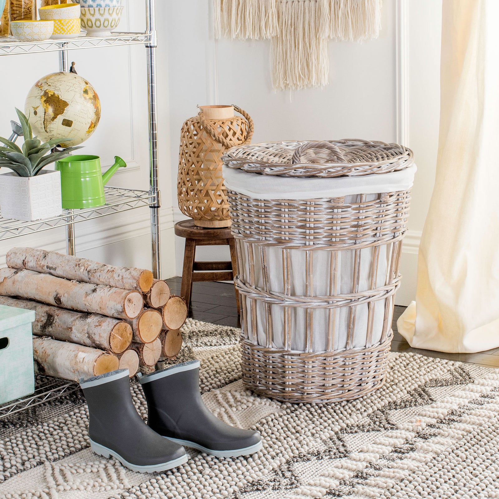 A lidded whitewashed rattan hamper offers discreet laundry storage and natural texture. || HAC6500A || front_room