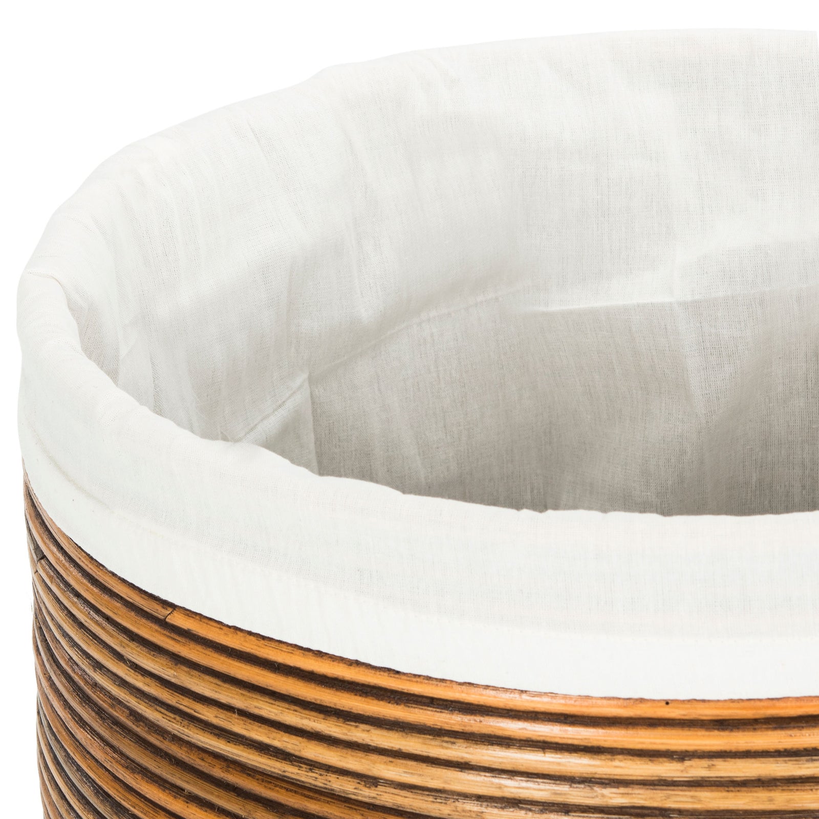 A white fabric liner folds over the rim of the honey-brown rattan hamper || HAC6501C || storage_open_studio