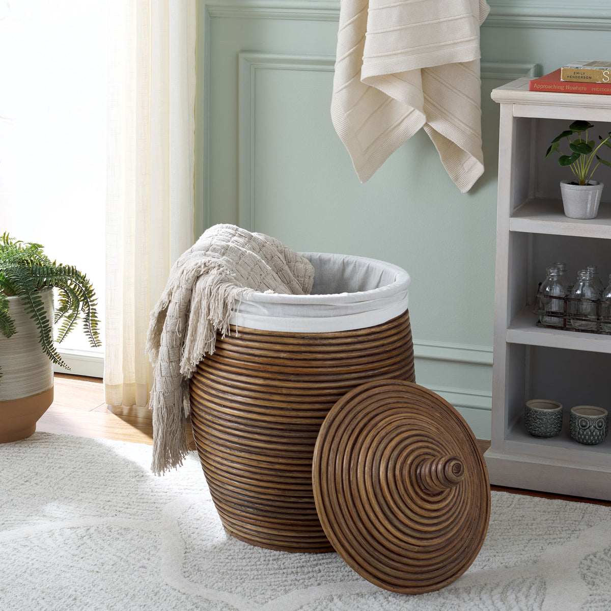 With its lid set aside, the fabric-lined basket offers easy access to blankets or laundry || HAC6503A || front_angle_open_room