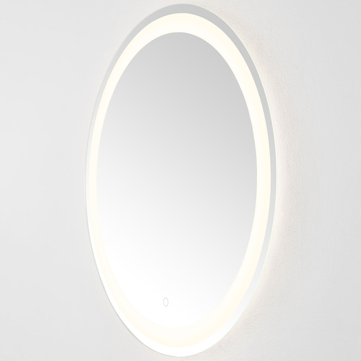 The slim, wall-mounted mirror casts a soft white glow from its circular LED band || LMR1001A || side_on_studio