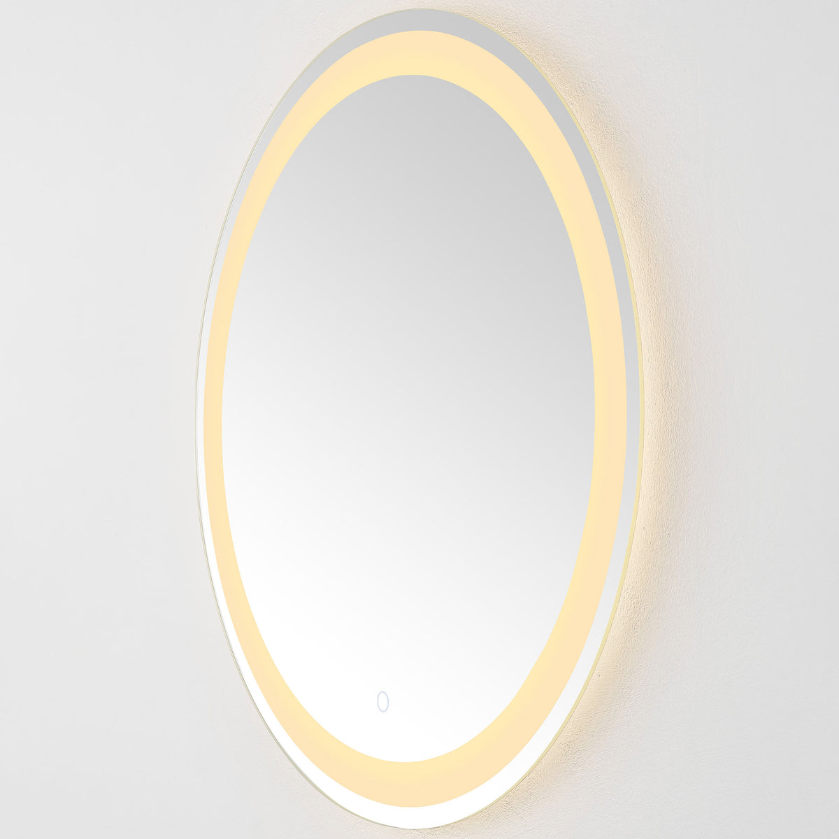 Warm LED light radiates from the round mirror's perimeter beside its slim silver edge || LMR1001A || side_on_studio