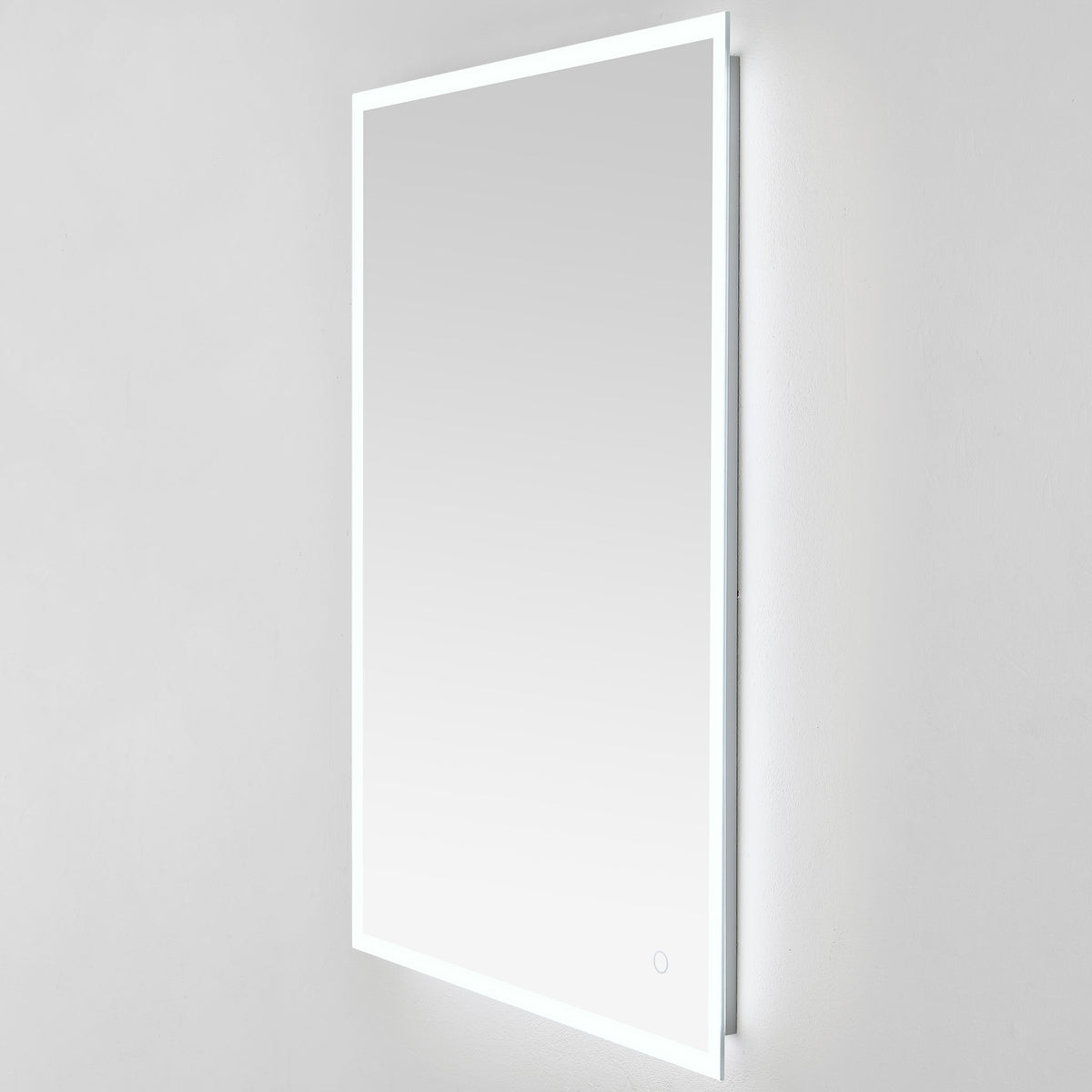The tall mirror glows cool white at its edges, with a shallow mount that sits close to the wall. || LMR1003A || front_angle_on_studio