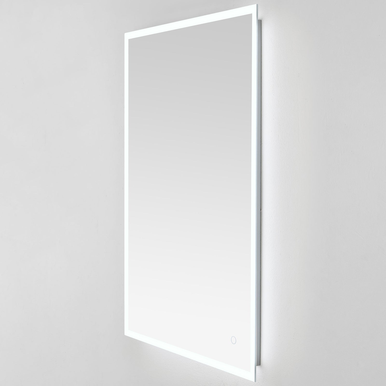 The tall mirror glows cool white at its edges, with a shallow mount that sits close to the wall. || LMR1003A || front_angle_on_studio