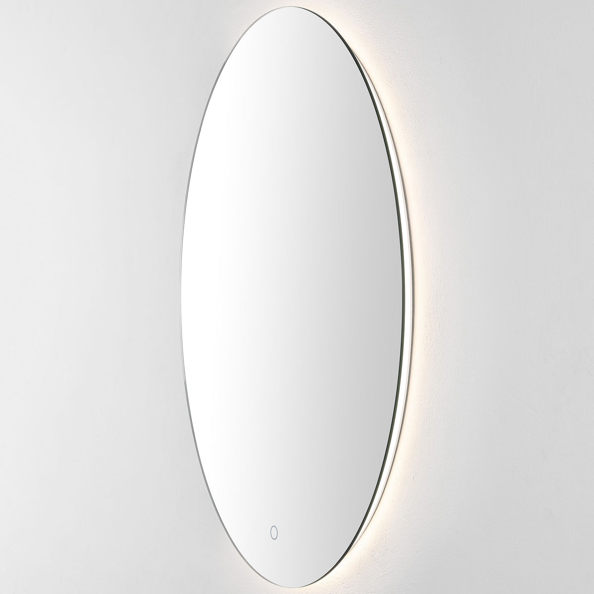 Warm-white backlighting gently illuminates the wall beyond the mirror's narrow edge || LMR1005A || front_angle_on_studio