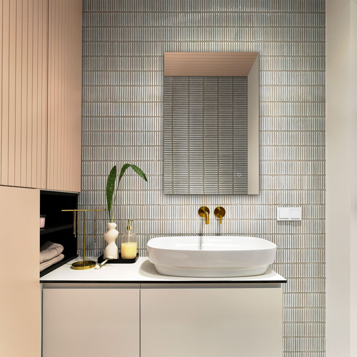A slim rectangular mirror brings a clean, reflective finish to a tiled bathroom vanity. || LMR1006A || front_room