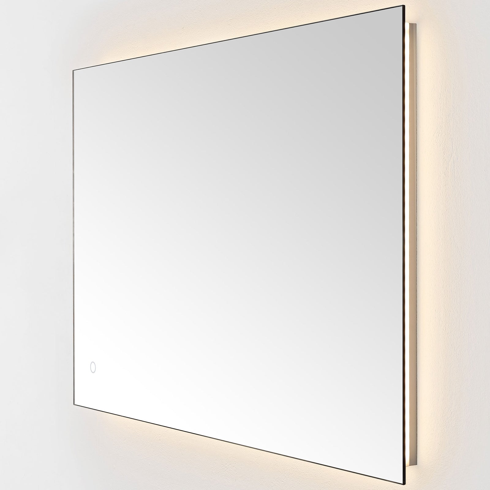 Warm backlighting washes the wall around the wide mirror's sleek, minimal silhouette. || LMR1006A || front_angle_on_studio