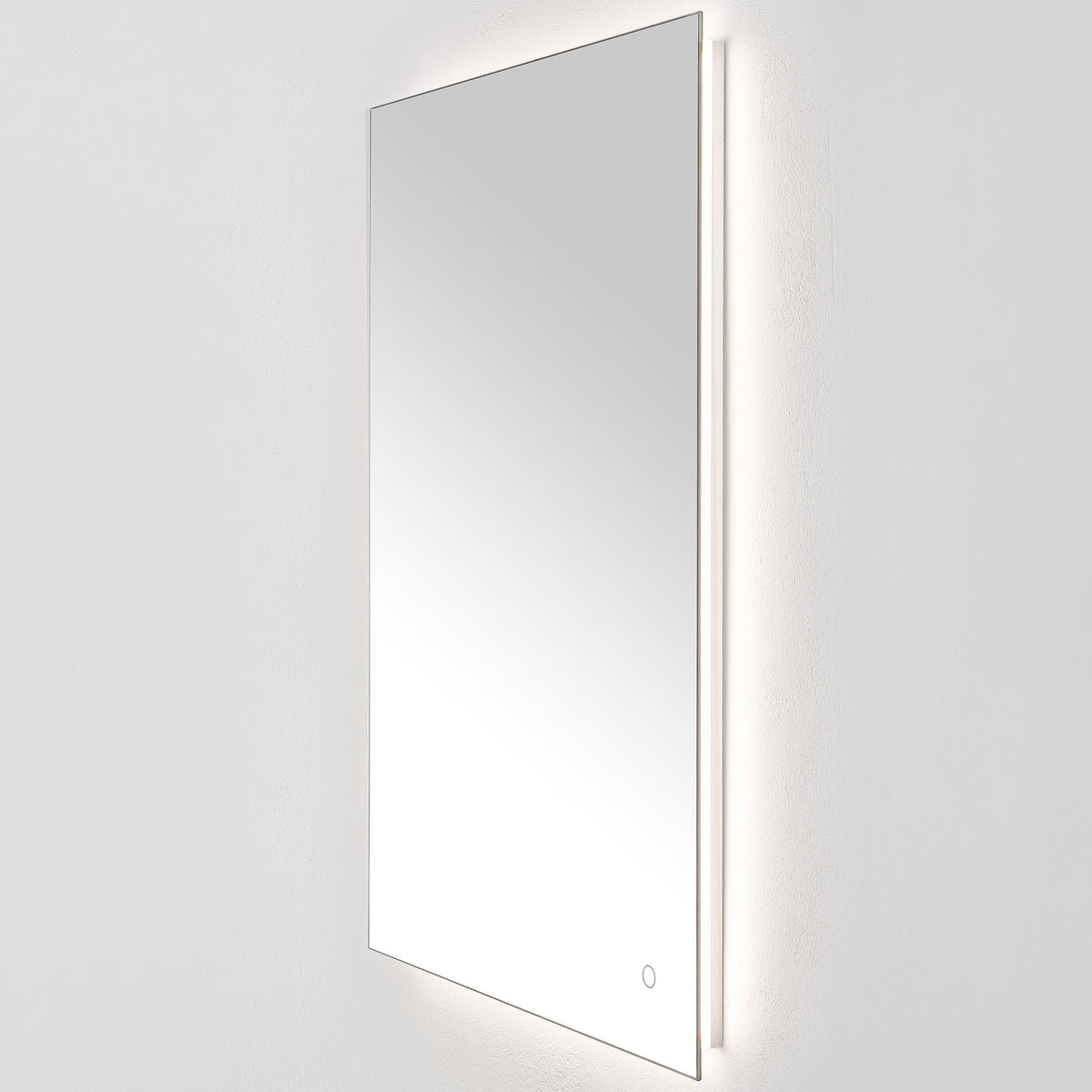 Gentle white backlighting outlines the tall mirror and its narrow aluminum-backed edge. || LMR1006A || front_angle_on_studio