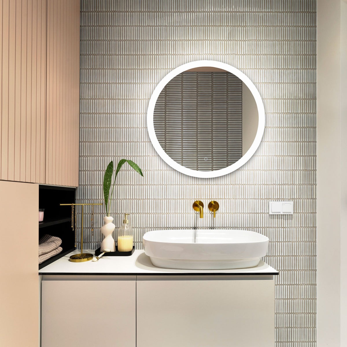 An illuminated white ring highlights the circular mirror above a streamlined bathroom vanity.