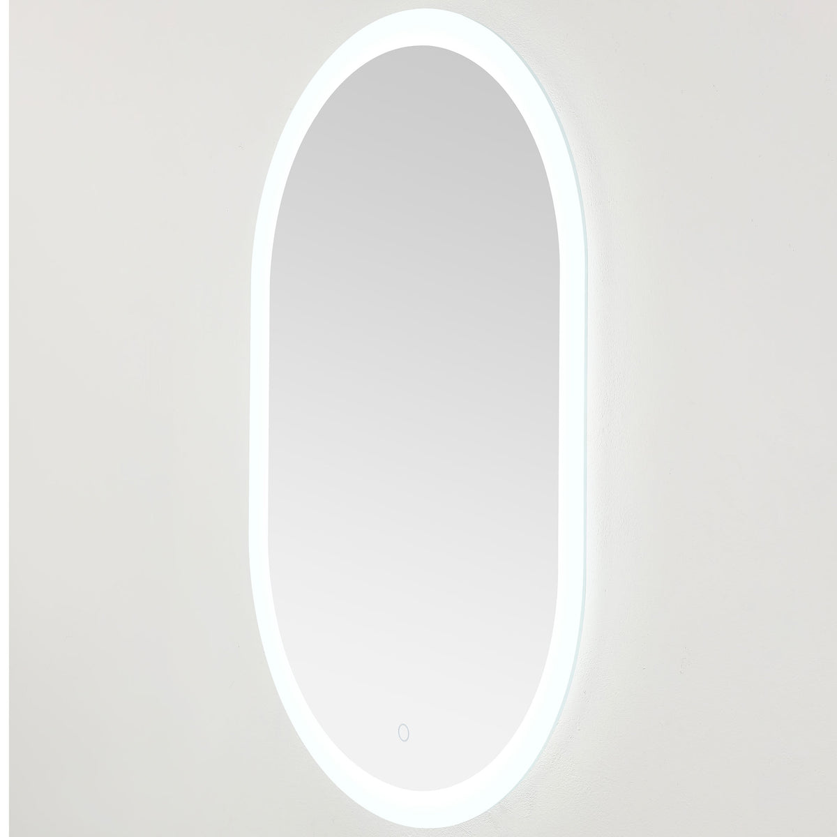 Cool white lighting outlines the slim oval mirror and creates a gentle wall glow || LMR1009A || front_angle_on_studio