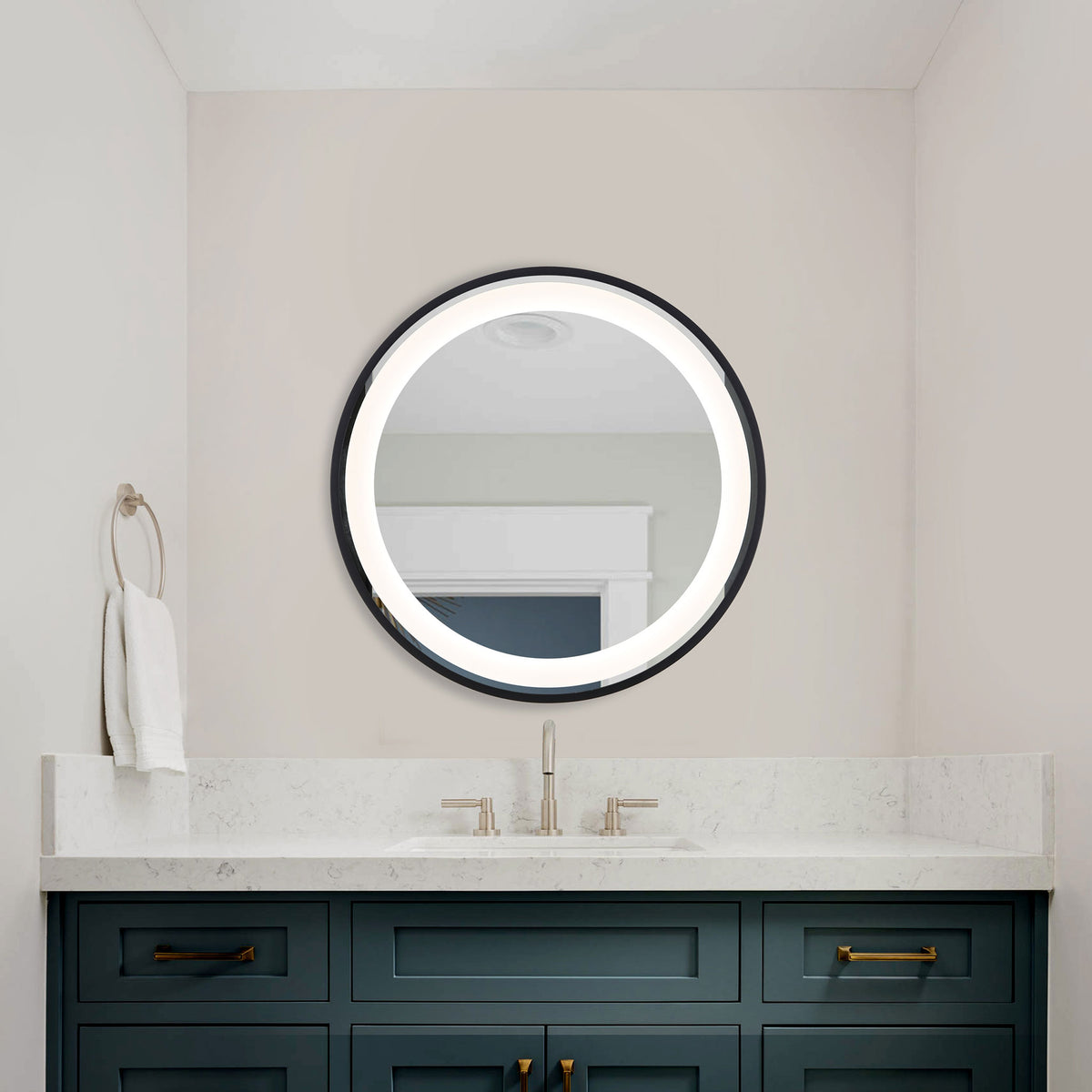 The round mirror's glowing white LED border lights the space above a blue bathroom vanity. || LMR1010A || front_on_room