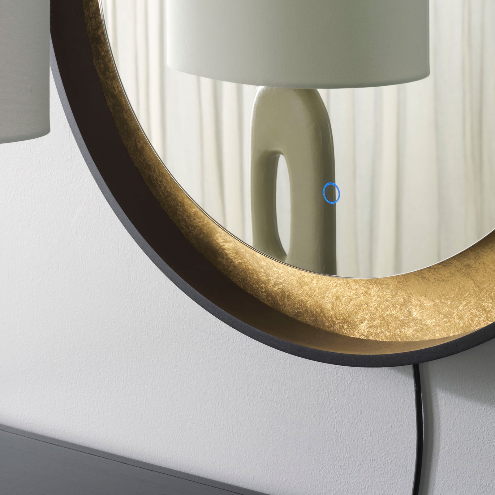 Textured gold-leaf trim lines the mirror inside a clean black outer rim. || LMR1014B || detail_room