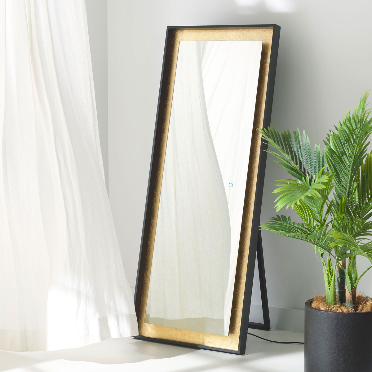 Gold leaf trim and a clean black frame define this freestanding, full-length mirror. || LMR1015B || front_angle_room
