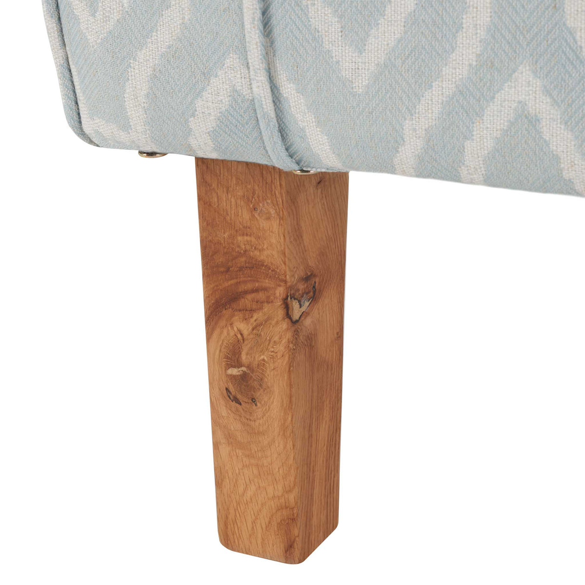 Wood leg with natural grain and knots complements the light blue trellis upholstery || MCR1002G || leg_studio