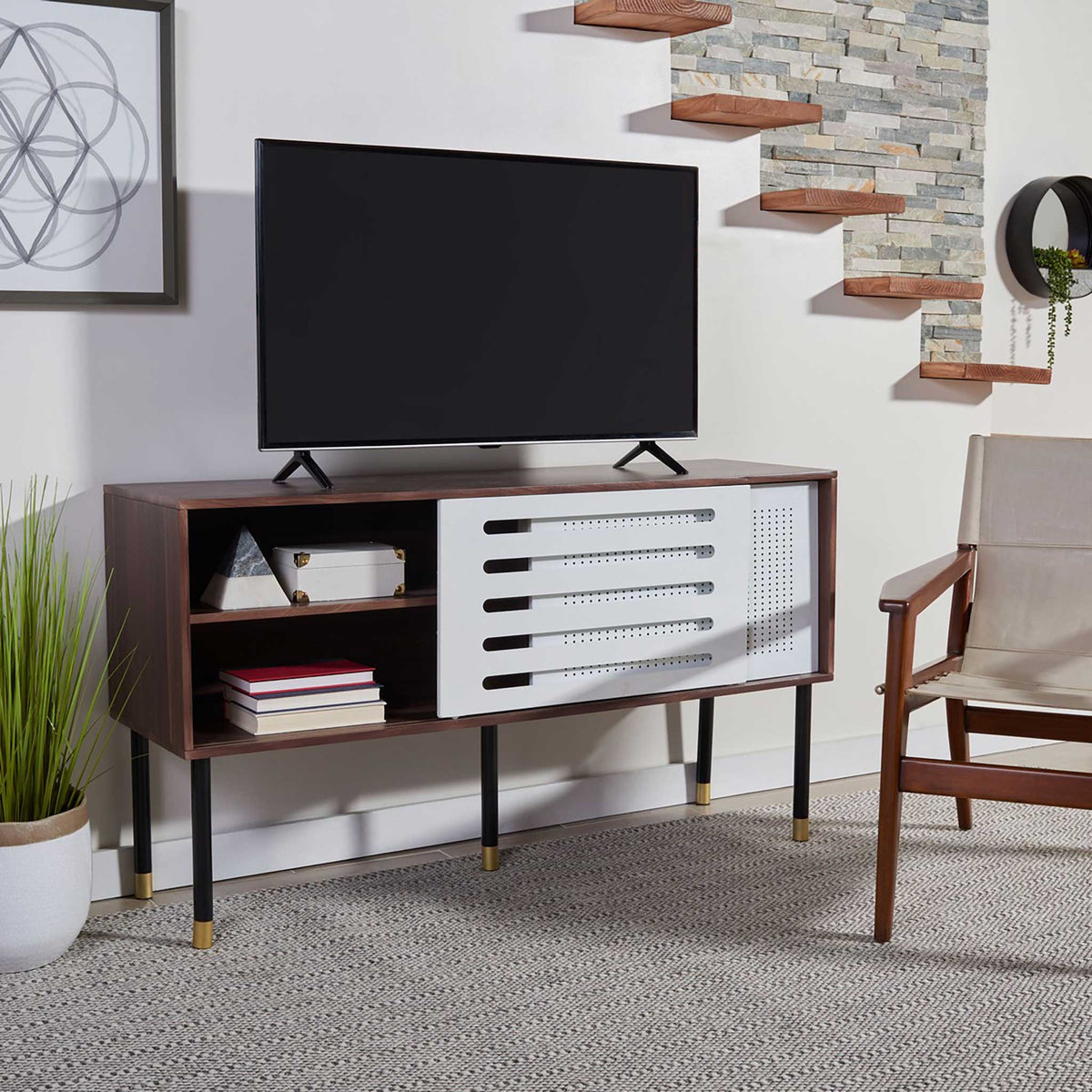 Open shelves display books and decor beside a sliding white door in the walnut-toned stand.