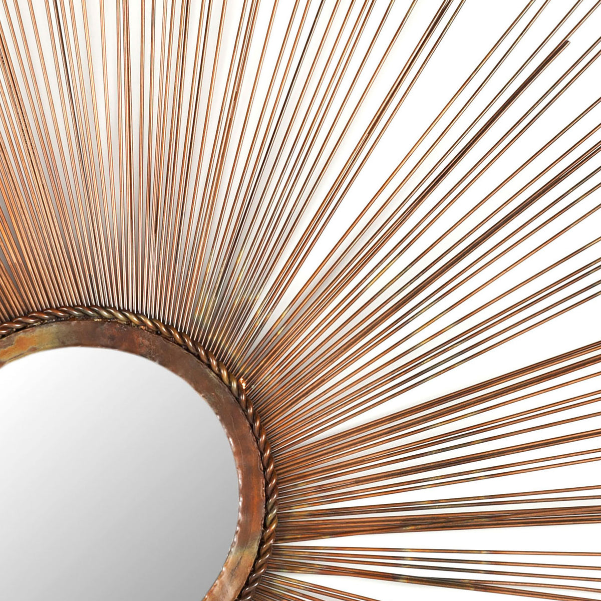 Warm copper rays fan out from a textured ring framing the circular mirror