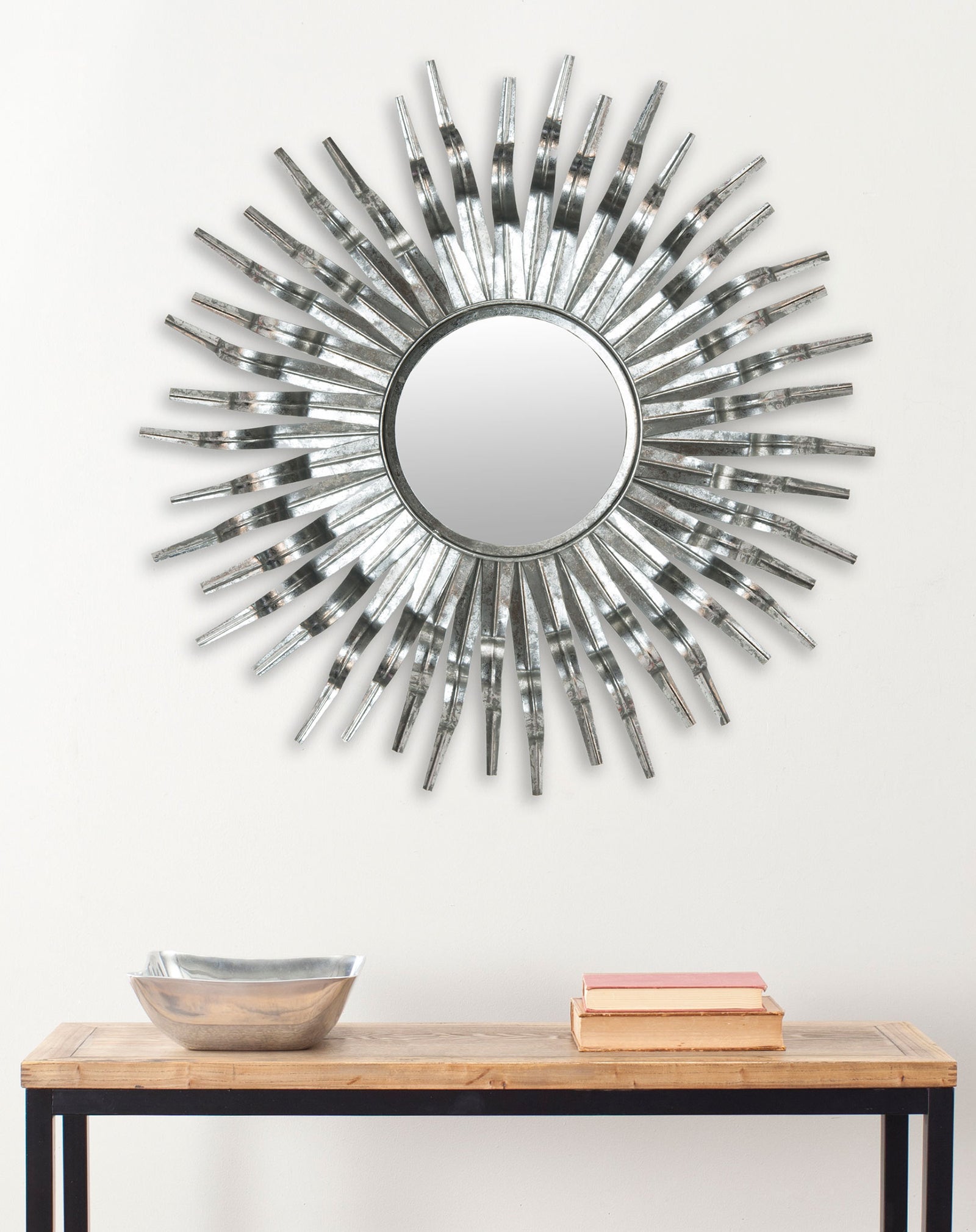 A silver sunburst mirror adds metallic dimension above a slim wooden console || MIR3007C || front_room