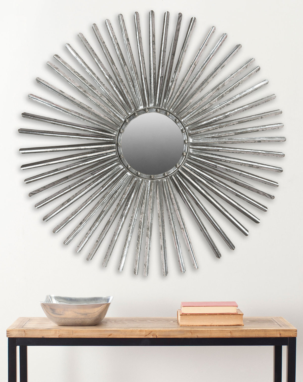 A silver sunburst mirror adds a bright focal point above a wood-topped console. || MIR3011B || front_room