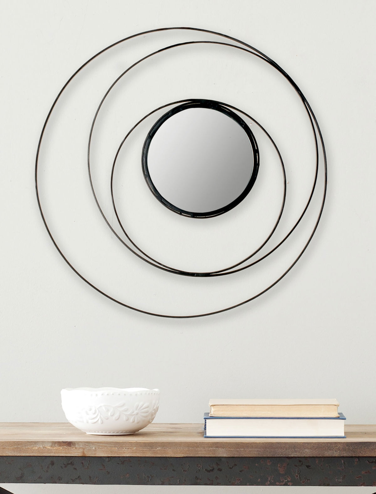 Overlapping black rings surround a round mirror for an airy wall accent || MIR4012A || front_room