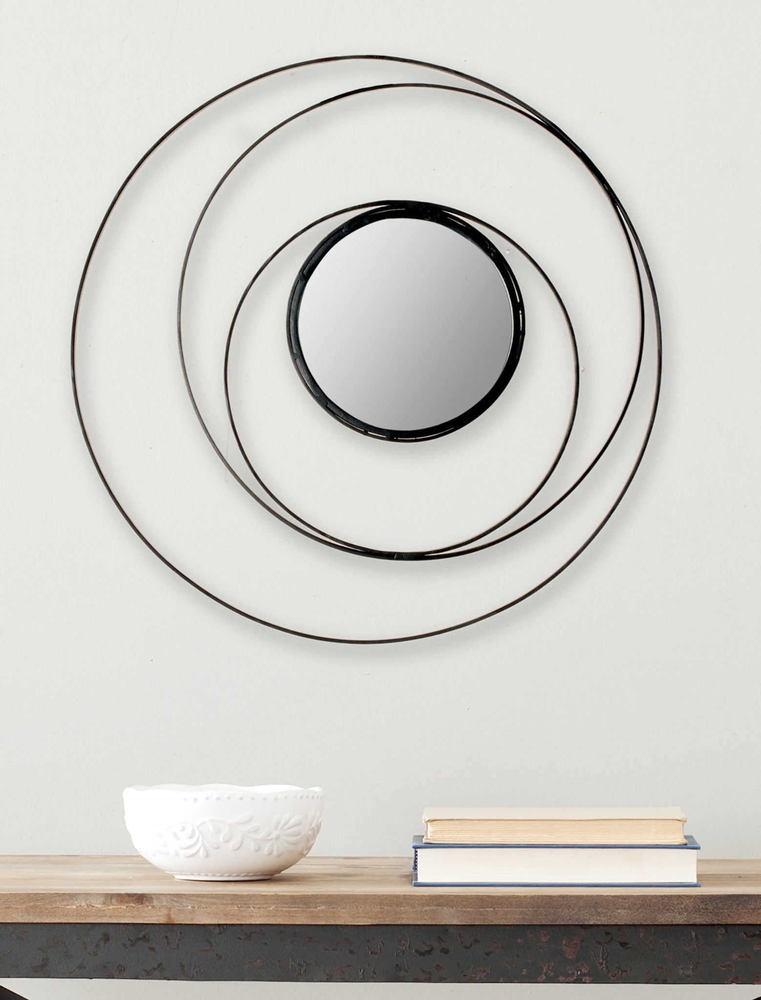 Overlapping black rings surround a round mirror for an airy wall accent || MIR4012A || front_room