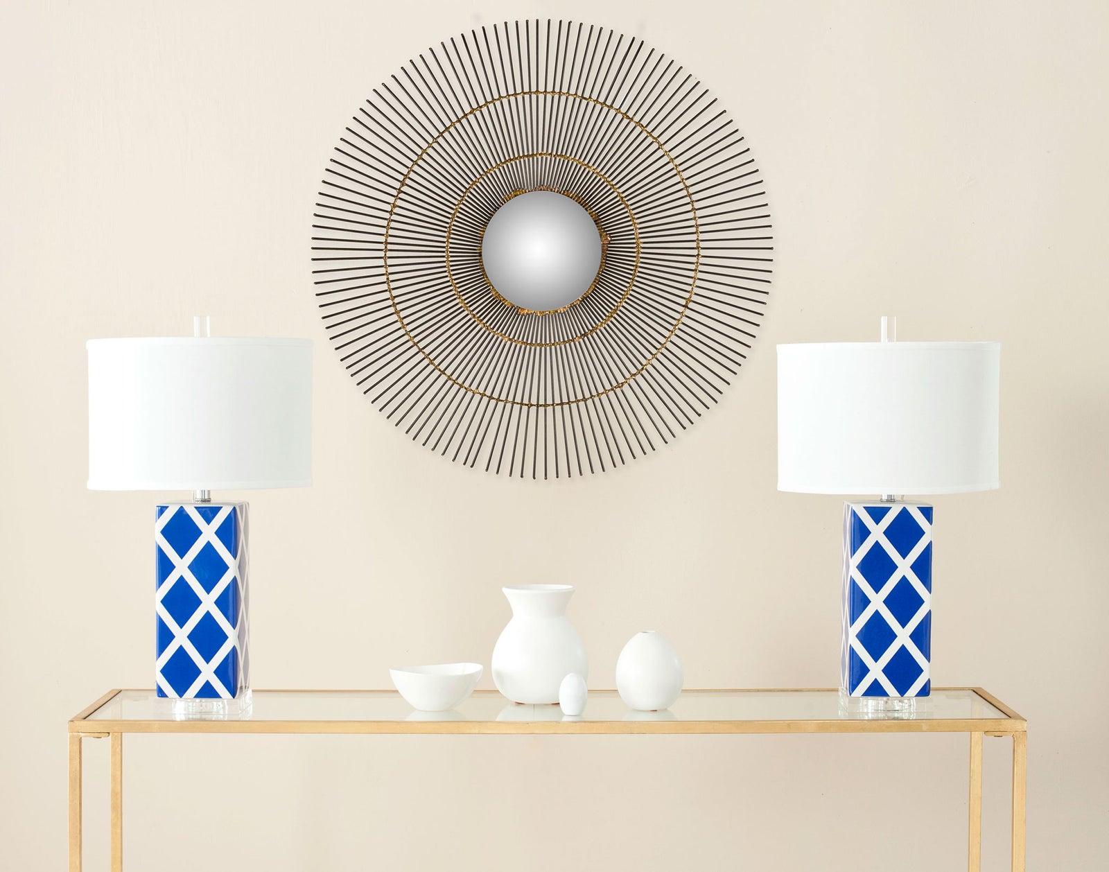 An airy metal sunray frame encircles a small mirror, adding warm metallic detail to the wall. || MIR4021A || front_room