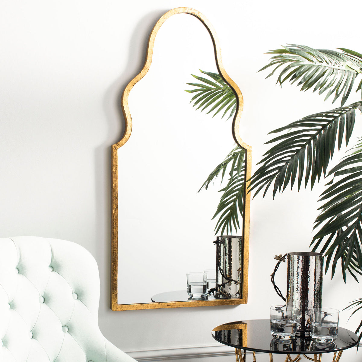 An arched gold mirror adds graceful curves and a warm metallic accent to a bright living space. || MIR4094A || front_room
