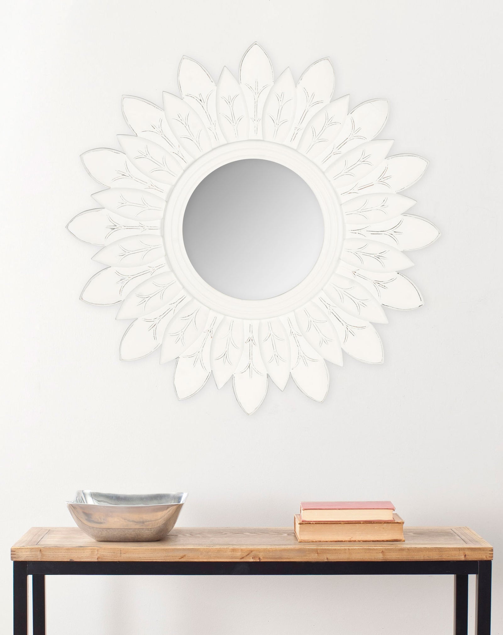 An antique white sunburst mirror brings sculptural detail to a wall above a console || MIR5003D || front_room