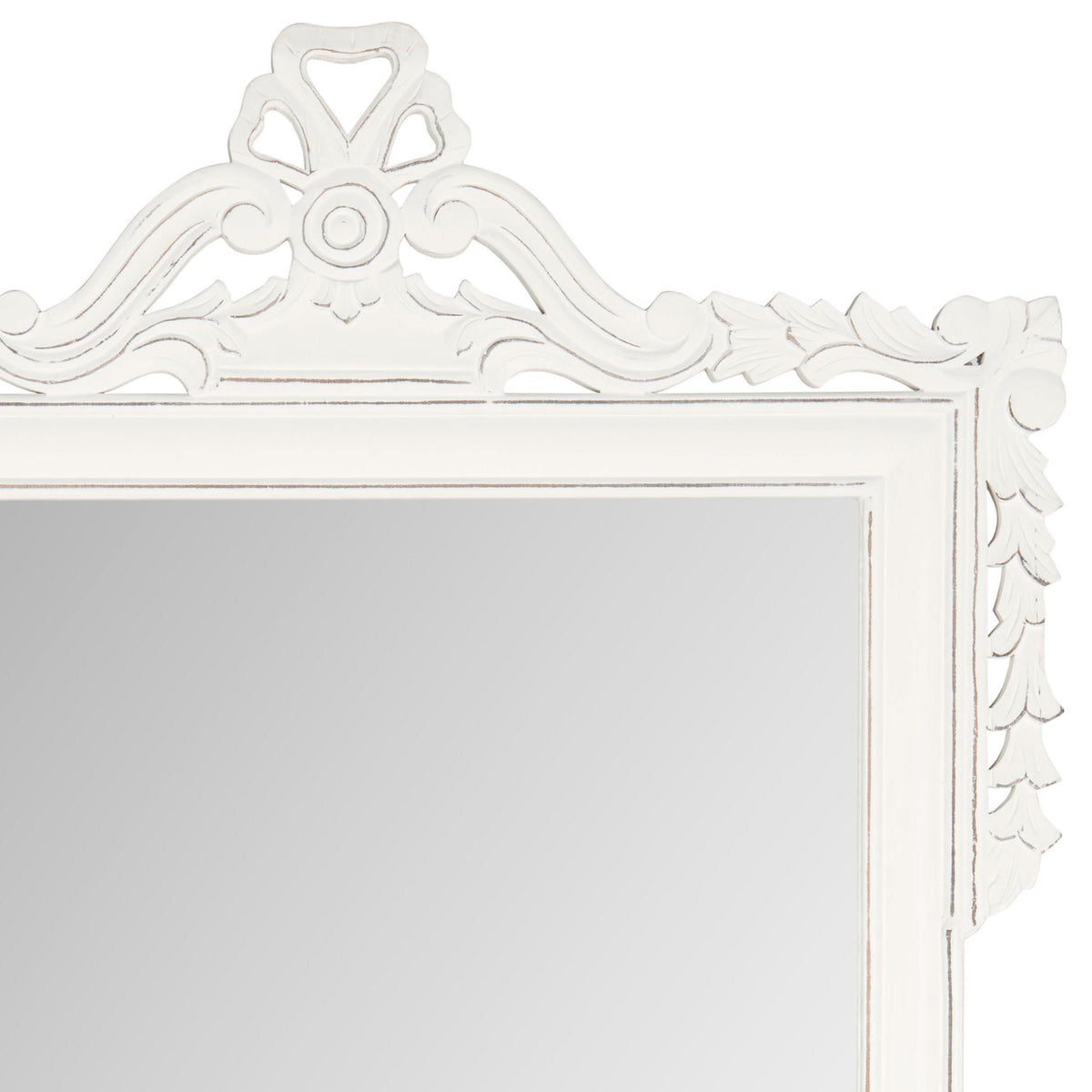 Antique white scrollwork and a carved crest add graceful detail above the mirror