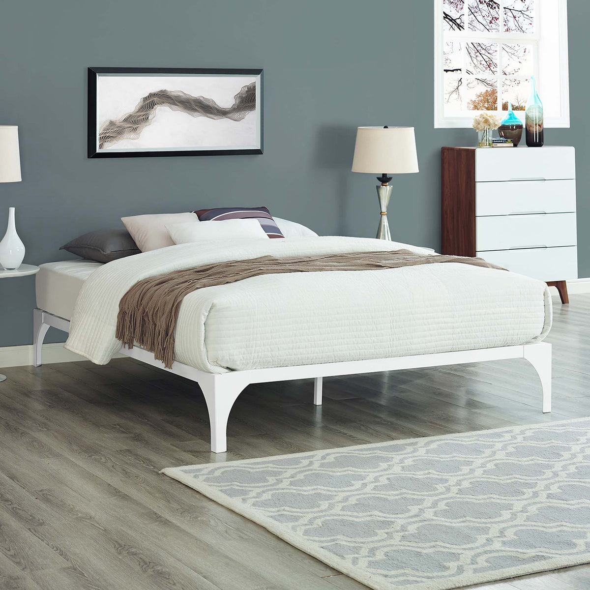 Airy white platform bed brings clean lines and graceful arches to the bedroom