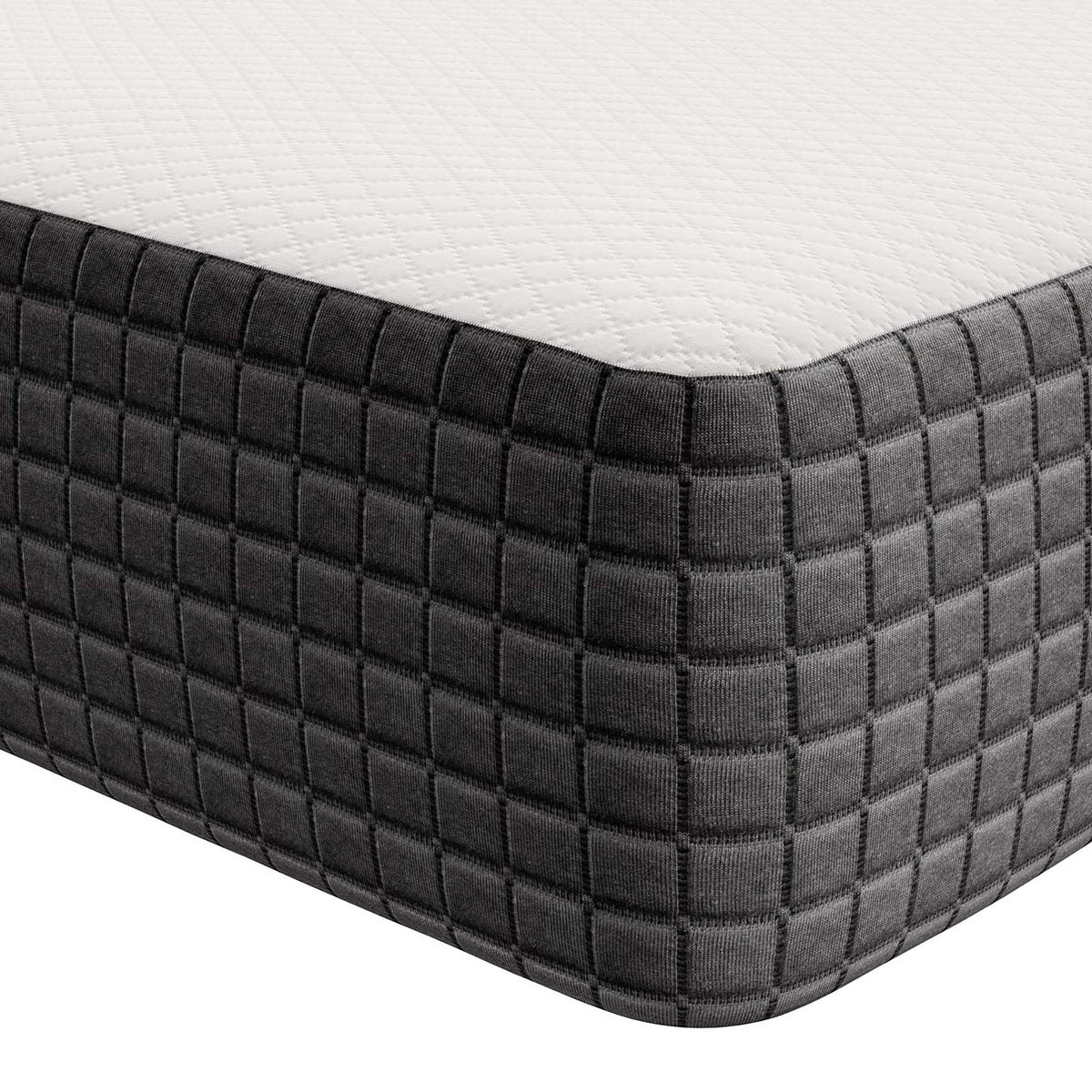 Deep square quilting shapes the charcoal mattress corner below a white knit top.