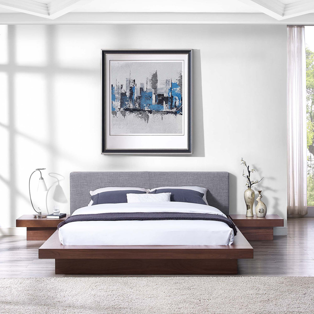 A gray upholstered headboard and matching side tables give this walnut bed a cohesive look