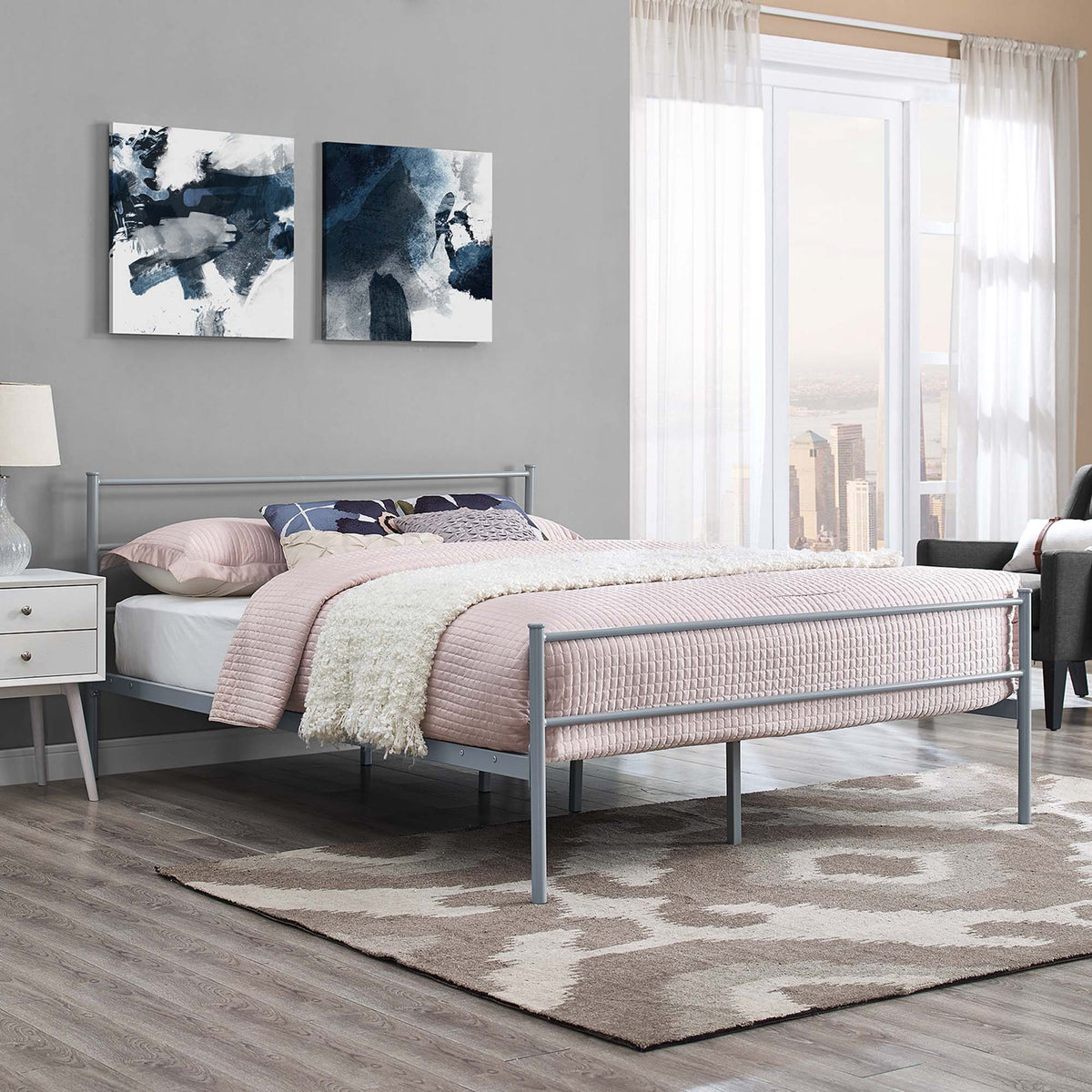 Gray platform bed brings simple rail accents and an elevated frame to a cozy bedroom.