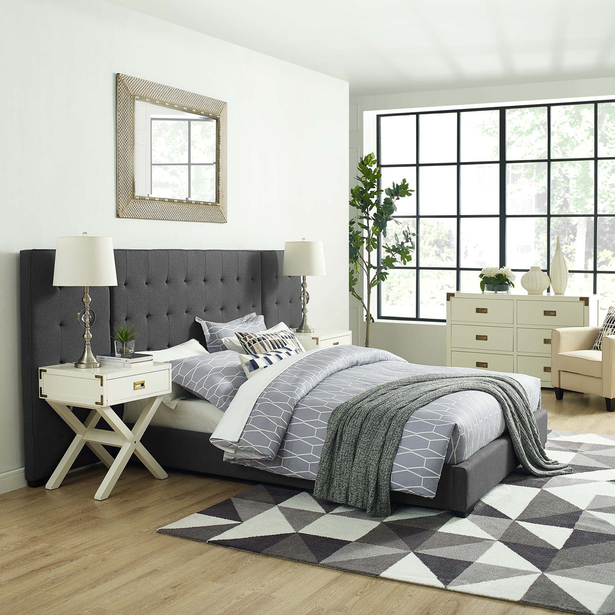 A gray biscuit-tufted headboard lends tailored style to the upholstered bed.