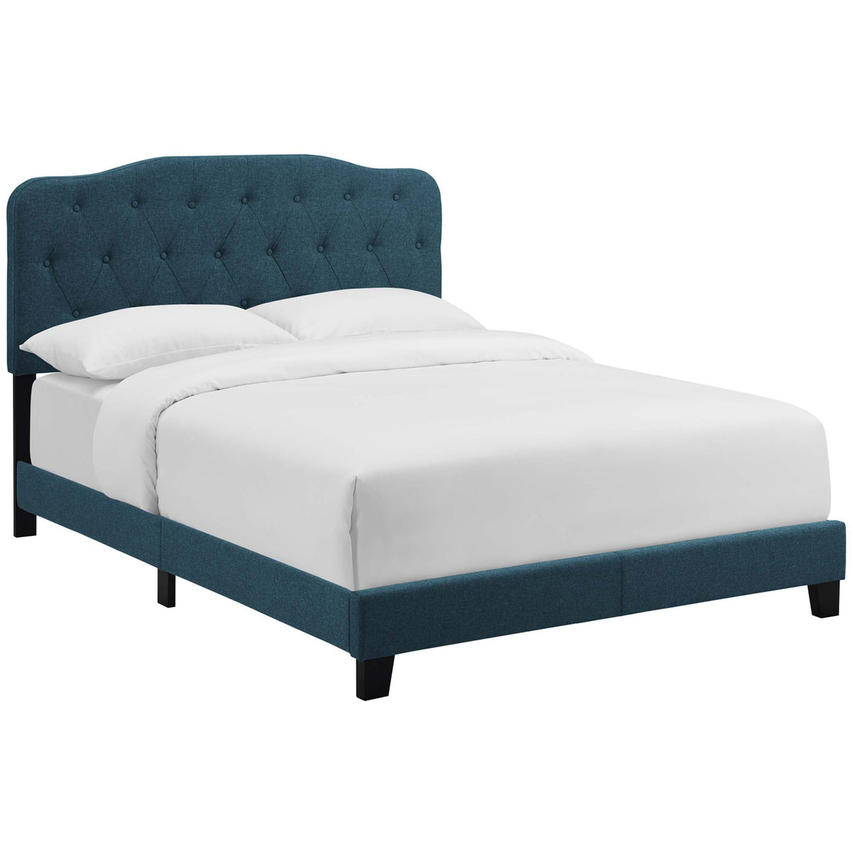 Azure fabric bed pairs a plush tufted headboard with low upholstered rails and dark wood legs