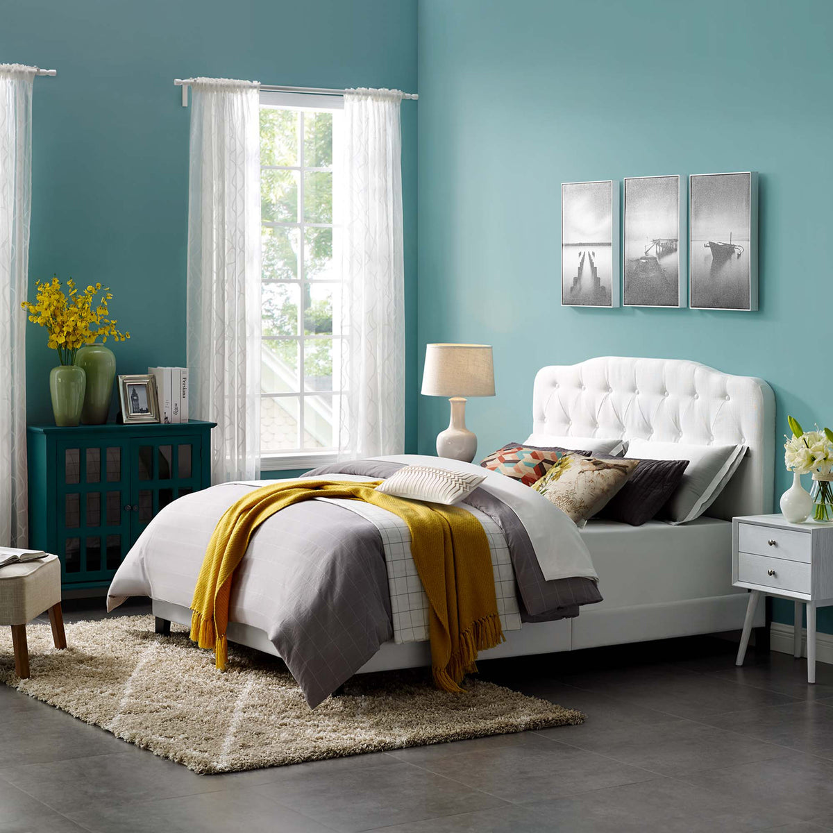 White button-tufted bed adds a soft, inviting centerpiece to a bright bedroom