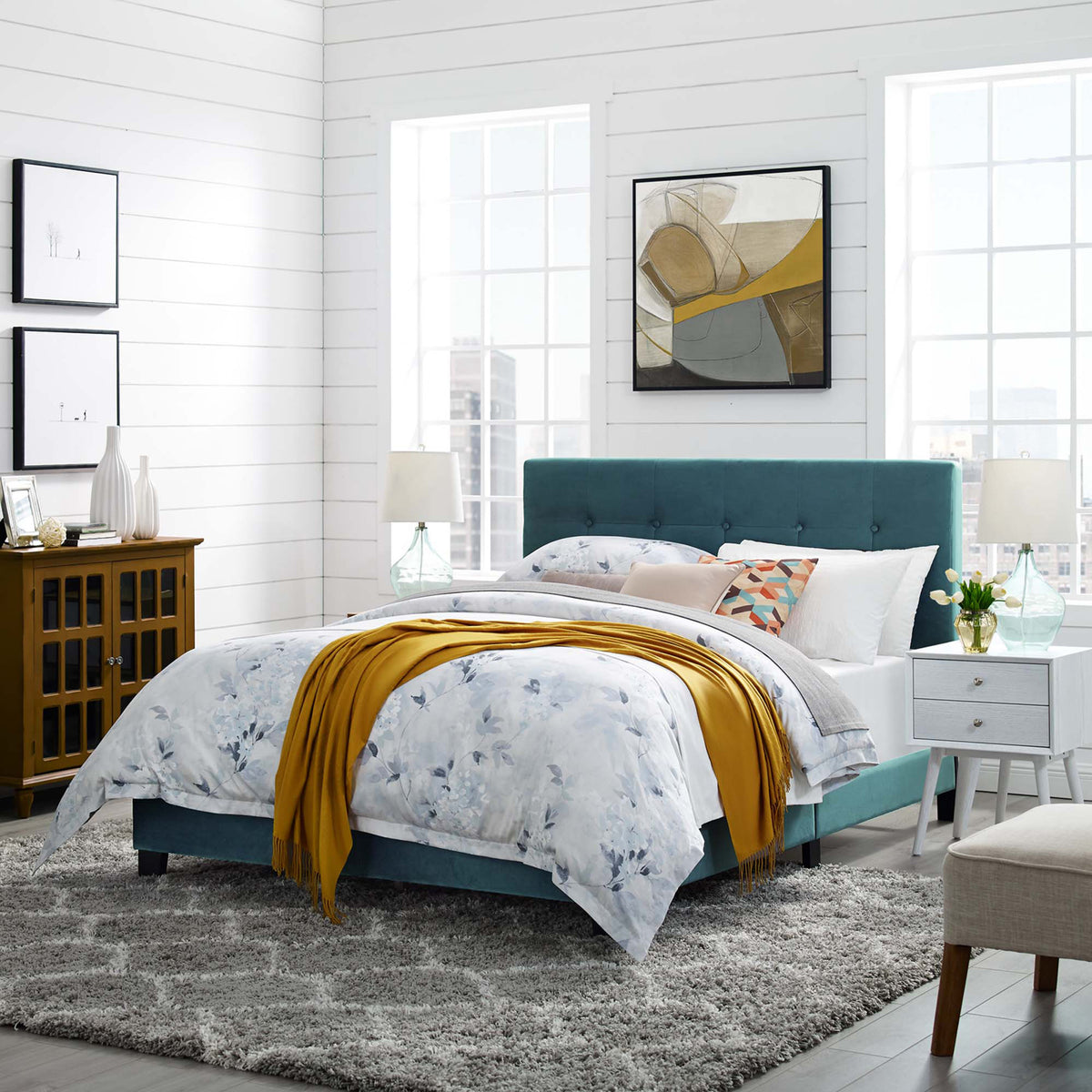 Sea blue velvet queen bed adds rich color and button-tufted texture to a bright bedroom.