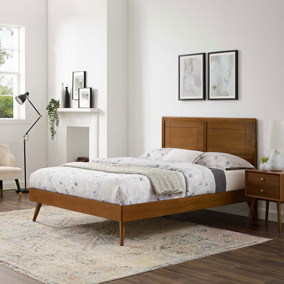Streamlined platform bed with splayed legs and paneled headboard anchors a modern bedroom || MOD-6382-WAL || front_angle_room