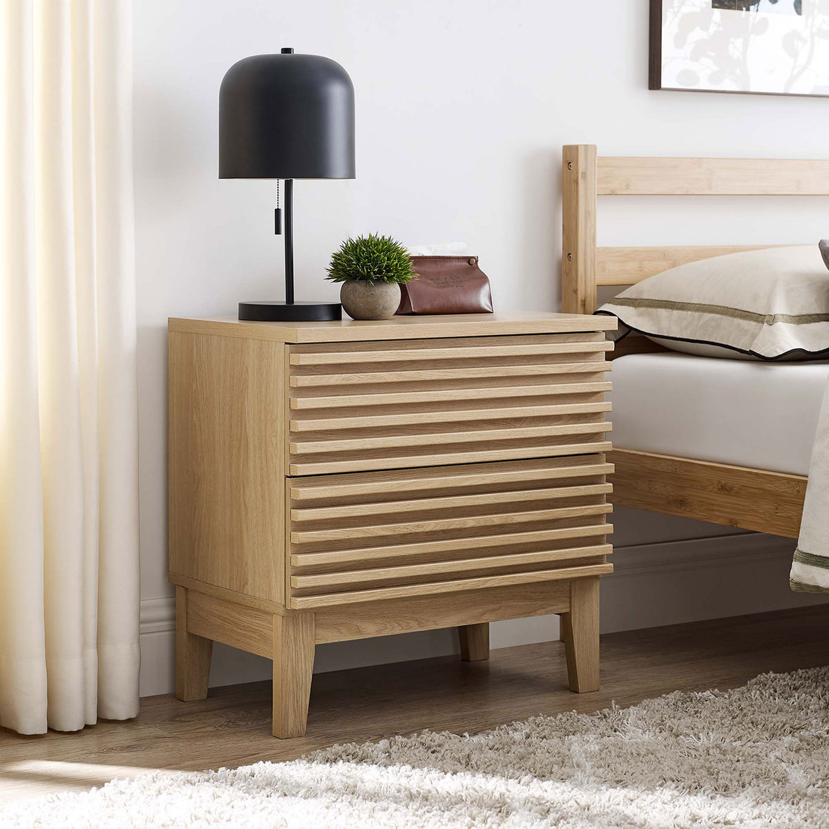 Render oak nightstand beside a modern bed, topped with a sleek lamp and decor for warm bedroom style || MOD-6964-OAK || front_angle_room