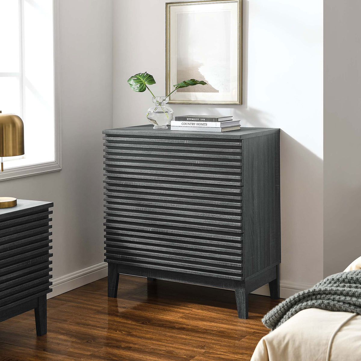 Charcoal bachelor's chest styled with decor accents and warm wood flooring in a modern bedroom || MOD-6965-CHA || front_angle_room