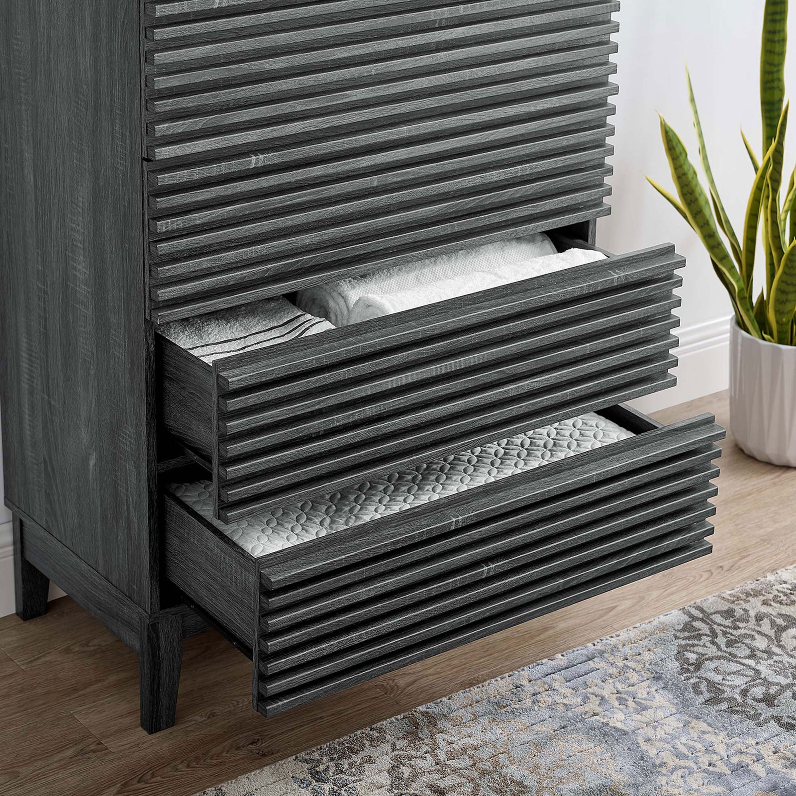 Open dresser drawers neatly storing blankets and linens, showcasing smooth glides and charcoal wood grain finish. || MOD-6967-CHA || storage_open_room