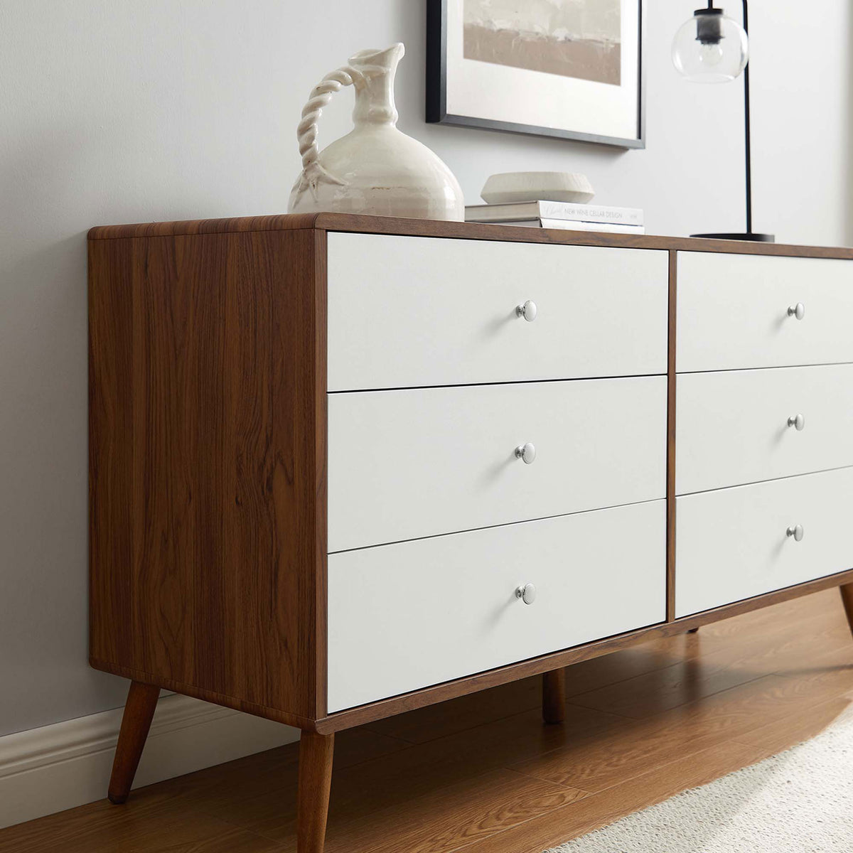 Walnut and white dresser surface styled with a sculptural pitcher and decor on warm wood flooring. || MOD-7022-WAL-WHI || detail_room