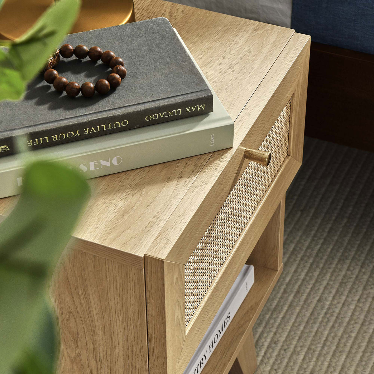 Detail of Soma nightstand top showing smooth oak finish, chamfered edges, and woven rattan drawer front || MOD-7049-OAK || detail_room