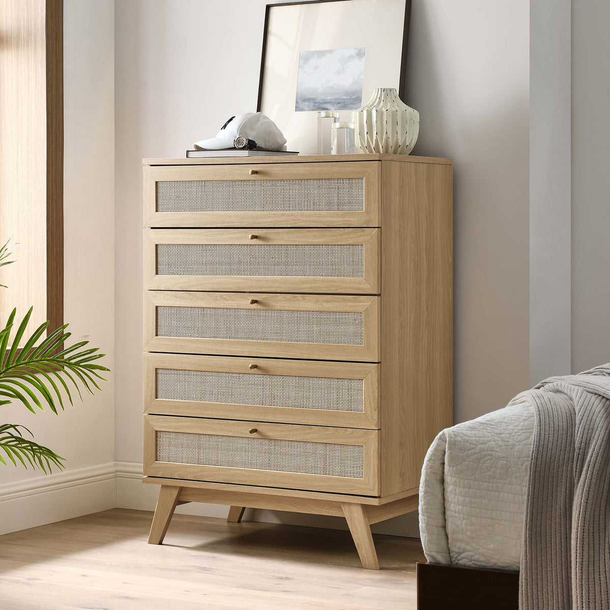 Oak 5-drawer chest styled in a cozy bedroom with decor on top and warm natural light || MOD-7052-OAK || front_angle_room