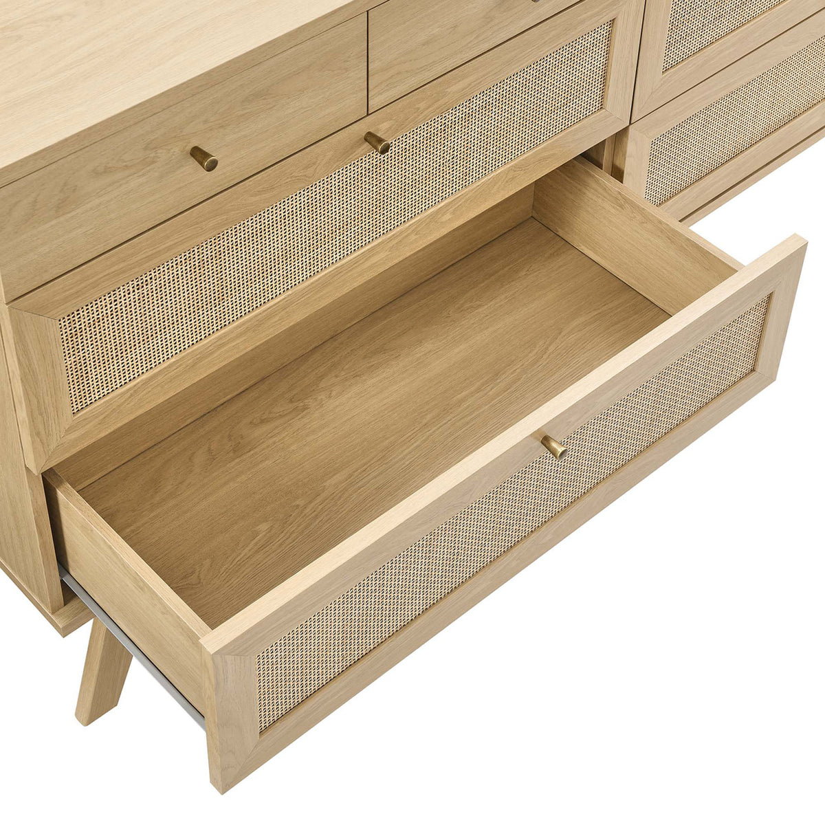 Open lower drawer revealing deep storage space and rattan-accented front on the oak dresser || MOD-7054-OAK || storage_open_studio