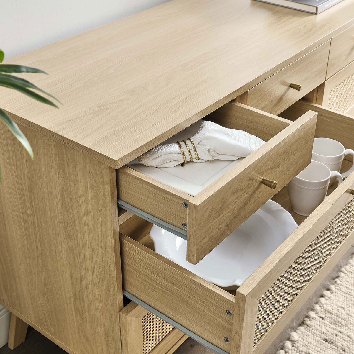Oak dresser styled with decor and open drawers neatly organizing dinnerware and linens || MOD-7054-OAK || storage_open_room